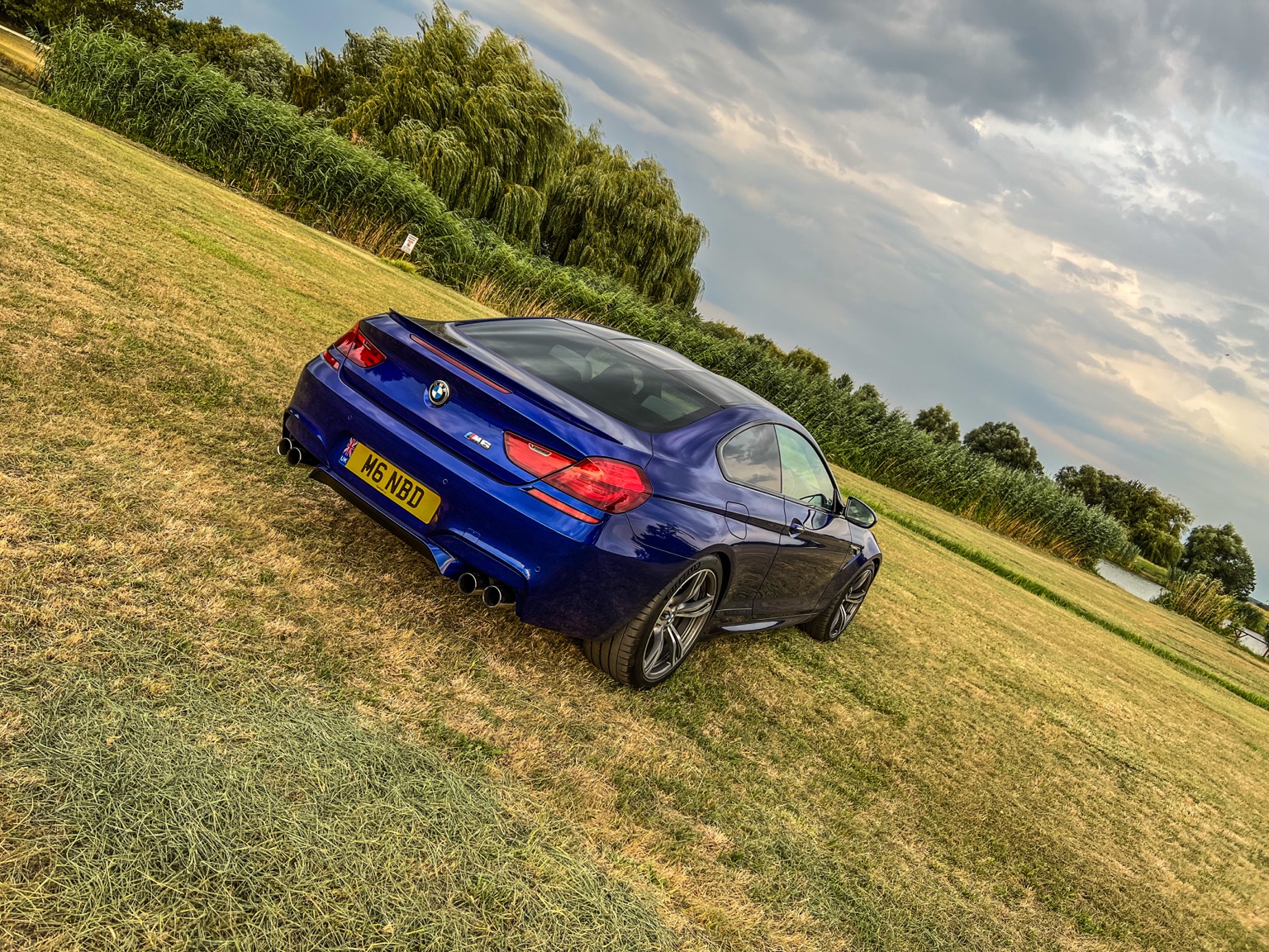 Blue BMW M6 parked beside the River Tisza